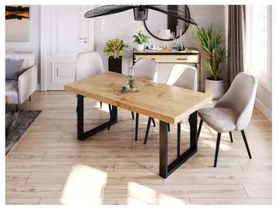 A dining room scene with a wooden table and chairs, plants, and a mirror.
