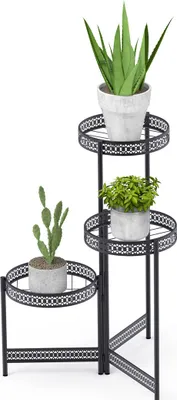 A black metal plant stand with three tiers, holding three different potted plants.