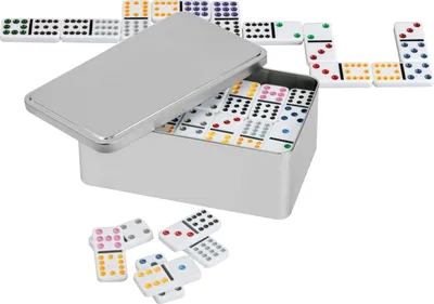A metal box filled with dominoes, with some dominoes scattered in front of it.