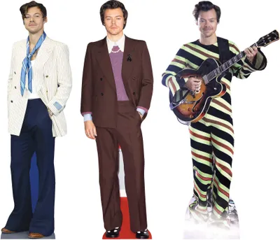 Three cardboard cutouts of Harry Styles in different outfits.