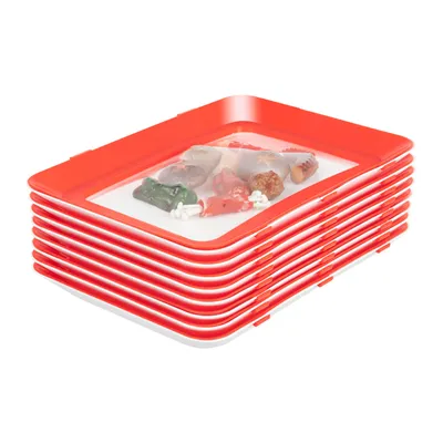 A stack of red and white food preservation trays with some food items inside the top tray.