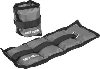 Two gray weight cuffs with black straps and buckles, one is coiled and the other is laid out flat.