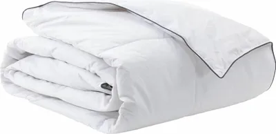 A folded white winter duvet with dark grey piping is shown against a white background.