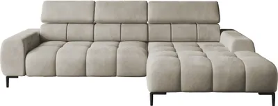A studio shot of a cream-colored sectional sofa.