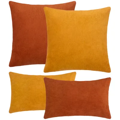 Four corduroy cushions in terra and yellow colors are arranged on a white background.