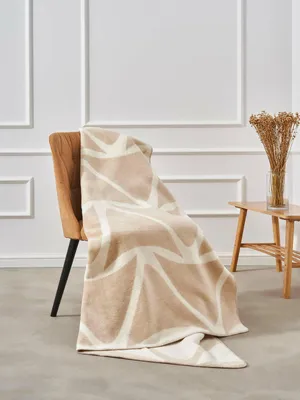 A blanket draped over a chair in a room.