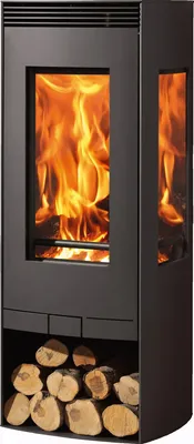 A modern black wood-burning stove with a glass door showing flames, and a storage compartment for firewood at the bottom.