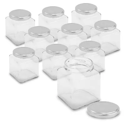 A group of clear, square jars with silver lids, arranged on a white background.
