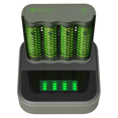 A battery charger with four AA batteries inserted, showing charging indicators on a digital screen.