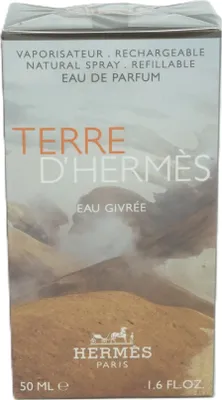 A close-up of a perfume box with a landscape image.