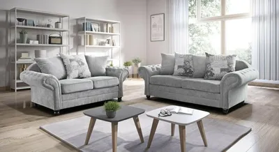 A living room setting with two sofas and coffee tables.