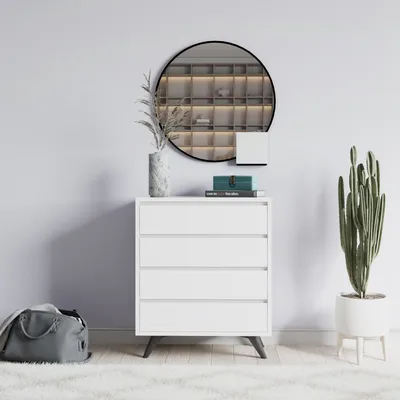 A white dresser with drawers is shown in a room with a mirror and a plant.