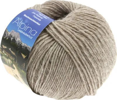 A ball of yarn with a label showing a mountain landscape and text.