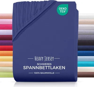 A folded navy blue fitted sheet is shown against a white background, with a stack of other colored sheets visible on the left and right sides.