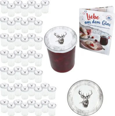 A collection of glass jars with lids, a jar of jam, and a recipe book.