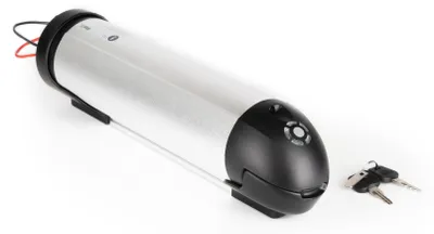 A silver cylindrical battery pack with a black end cap and two keys in front of it, set against a white background.