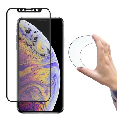 A hand holds a clear screen protector in front of an iPhone.