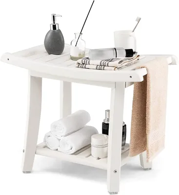 A white shower bench with various bathroom accessories on and under it.
