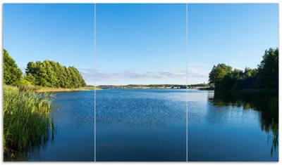 Produktbild von Wallario Herdabdeckplatte aus Glas, Größe 90 x 52 cm 3-teilig, Motiv Malerischer See mit Schilf unter blauem Himmel