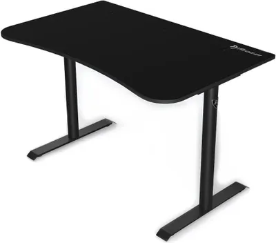 A black gaming desk with a curved front edge and two metal legs with flat bases, shown against a white background.