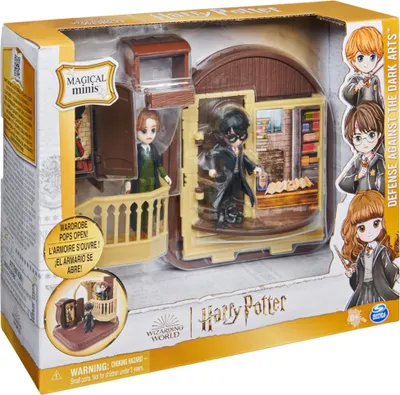 A toy playset of the Harry Potter 'Defense Against the Dark Arts' classroom, featuring miniature figures of Harry Potter and other characters.