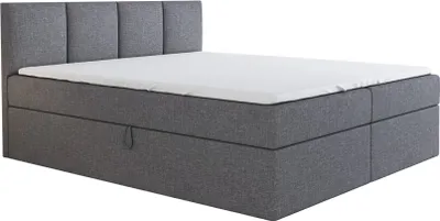 A grey boxspring bed with a white mattress and a grey headboard is shown against a white background.