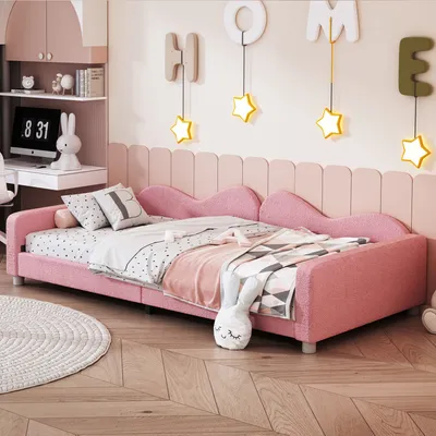A child's bedroom with a pink bed, desk, and decorations.