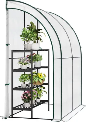A greenhouse with shelves filled with potted plants.