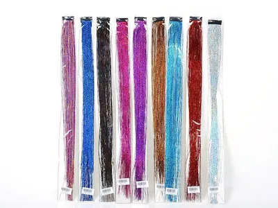 A collection of colorful, glittery hair extensions arranged vertically against a white background.