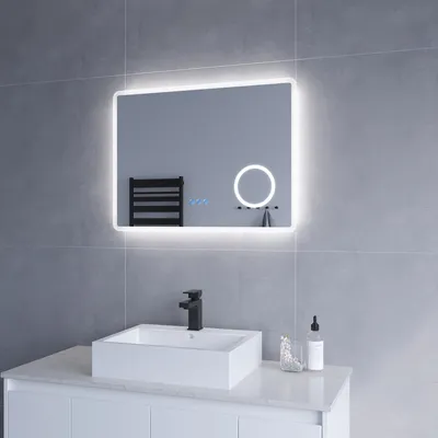 A modern bathroom vanity with a square sink, black faucet, and a lighted mirror above it.