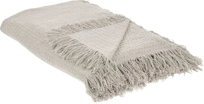 A light gray cotton blanket with fringes is folded and displayed on a white background.