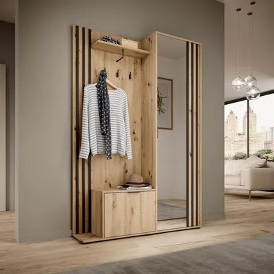 A modern entryway with a wooden wardrobe and mirror, a sofa and city view in the background.