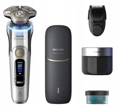 A collection of Philips grooming products, including an electric shaver, charging stand, trimmer attachment, and two containers of grooming product, arranged on a white background.