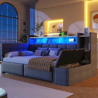 A modern bedroom with a large bed featuring integrated lighting and storage.