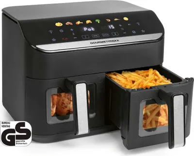 A black dual-basket air fryer is shown with one basket filled with french fries and the other showing cooked chicken.