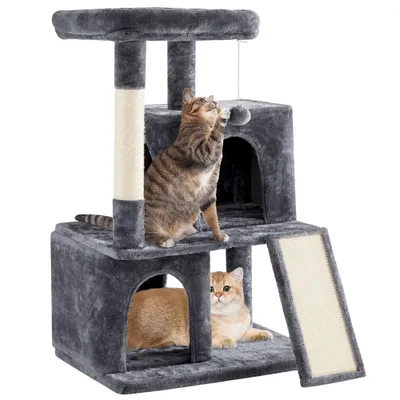 Two cats playing on a multi-level cat tree with scratching posts and a dangling toy.