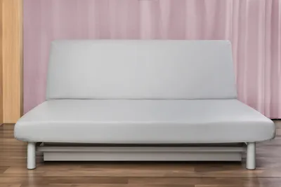 A light gray sofa bed is shown from the front in a room with pink curtains and wooden flooring.