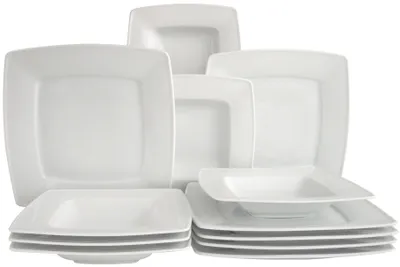 A collection of white square plates and bowls stacked and arranged.