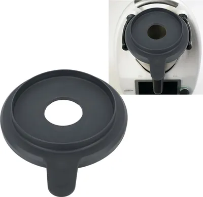 A dark gray funnel-shaped lid for a kitchen appliance is shown from two angles: one close-up and one attached to the appliance.