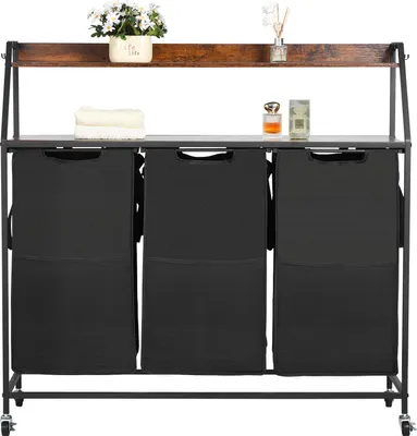 A laundry sorter with three compartments and a wooden top shelf, displayed in a studio setting.