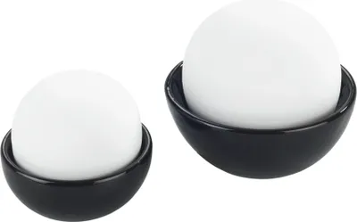 Two white spheres sitting in black bowls, isolated on a white background.
