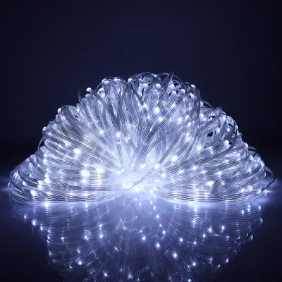 A coiled string of white LED lights on a dark background.