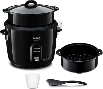 A black Tefal Classic 2 rice cooker with accessories, including a steamer basket, measuring cup, and rice paddle, displayed on a white background.
