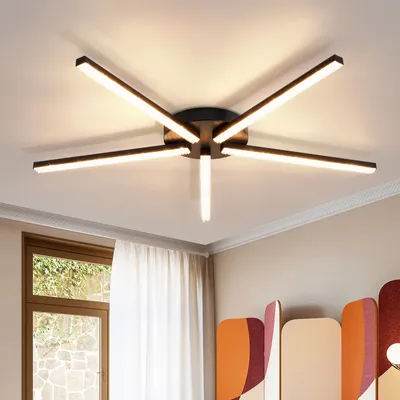 A modern LED ceiling light fixture with multiple arms extending from a central hub, illuminating a room.