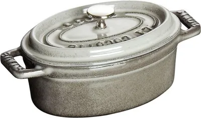 A Staub oval cocotte pot with a lid.