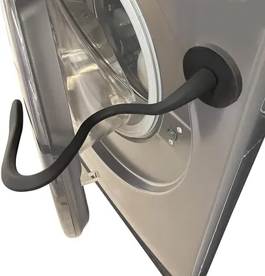 A close-up view of a black washing machine door support attached to the door of a washing machine.