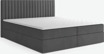 A dark gray boxspring bed with a white mattress and topper, shown from a side-angle against a white background.
