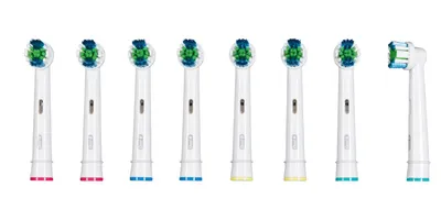 A collection of electric toothbrush heads arranged in a line against a white background.
