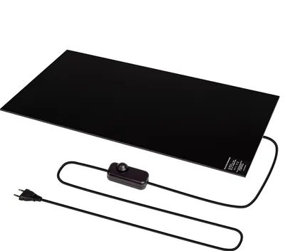 A black rectangular heating plate with a power cord and dimmer switch, presented on a white background.