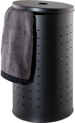A black laundry hamper with a grey towel draped over the side.